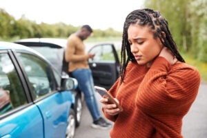 A rideshare accident victim calling a rideshare accident lawyer in aurora for help after a crash