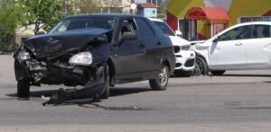 black car smashed after a double car crash