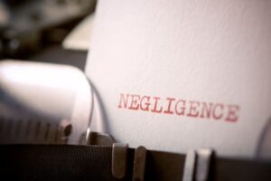 negligence typed on a paper in a typewriter